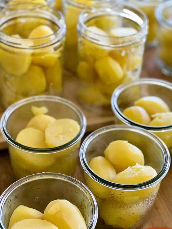 Geschälte Kartoffeln in Weckgläsern vorbereitet zum Einkochen im Pressure Canner mit Flüssigkeit im Glas
