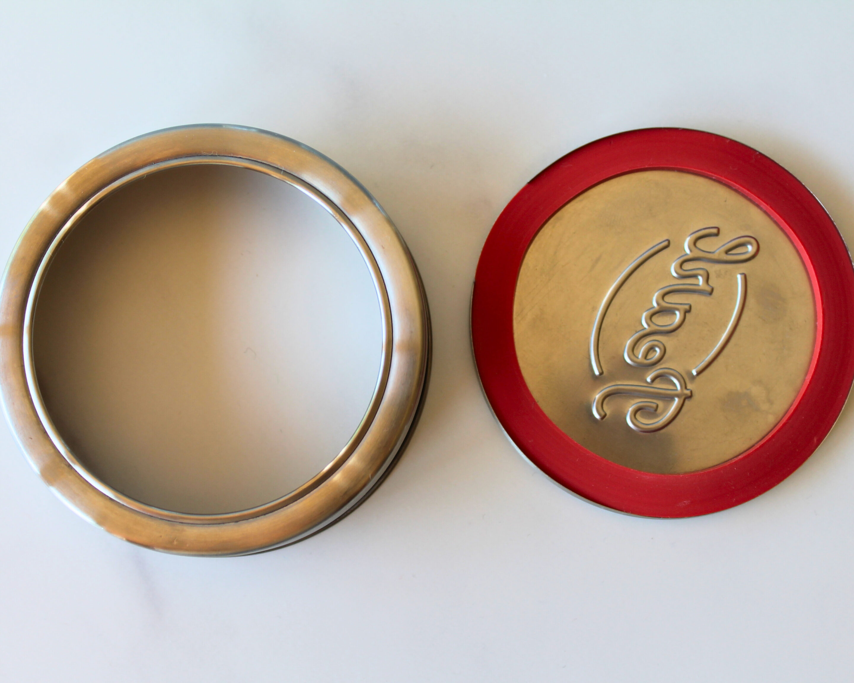 Zweiteiliger Deckel eines Pearl Jar Einmachglases bestehend aus Schraubring und Metalldeckel mit rotem Dichtungsring.